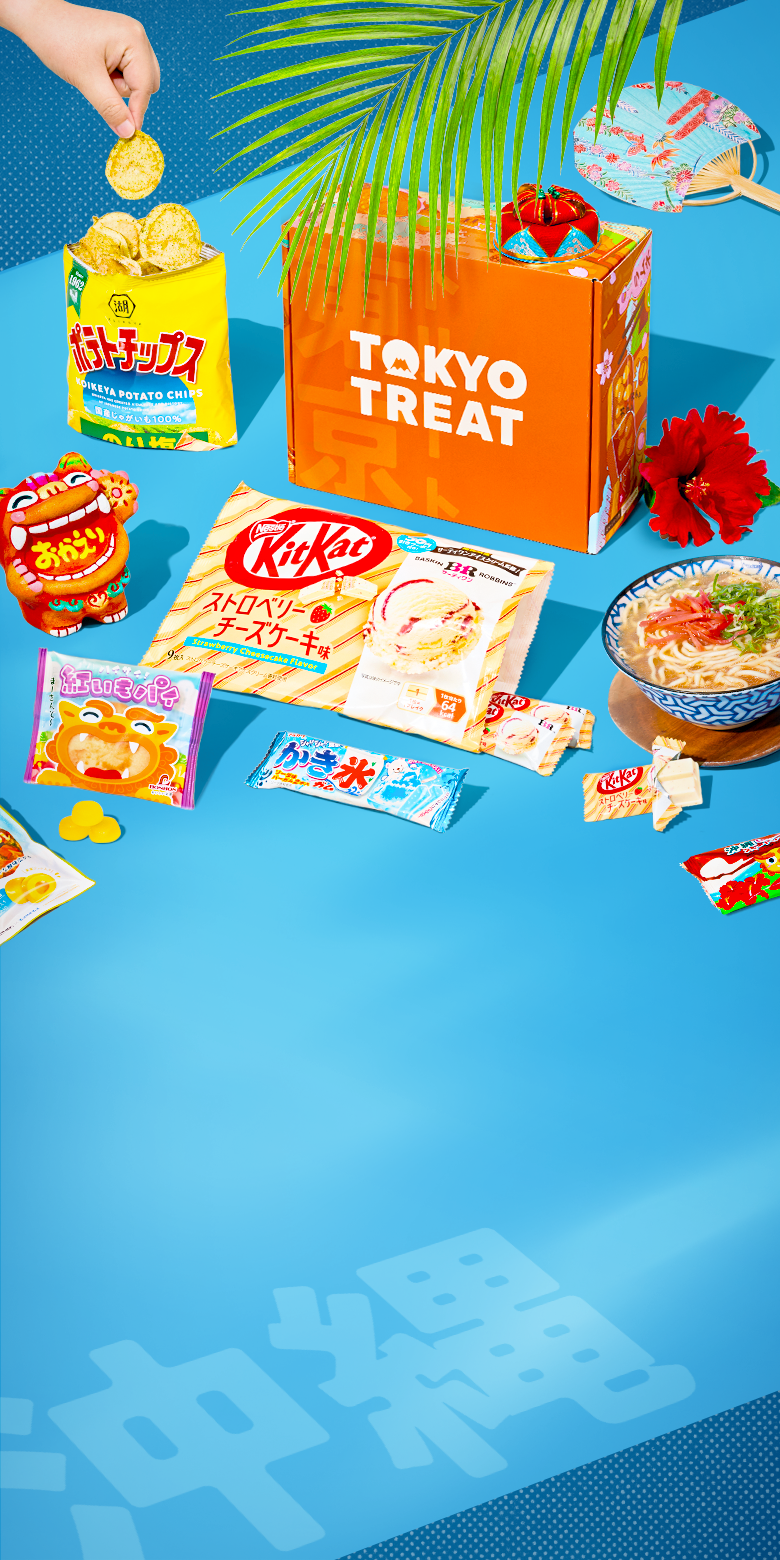 Orange TokyoTreat box on blue background with Okinawa-themed snacks around it 
