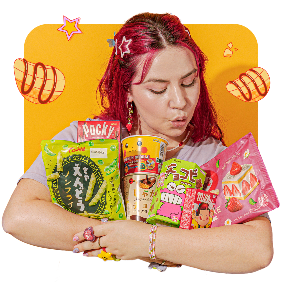 Woman with pink hair holding Japanese snacks on orange background 