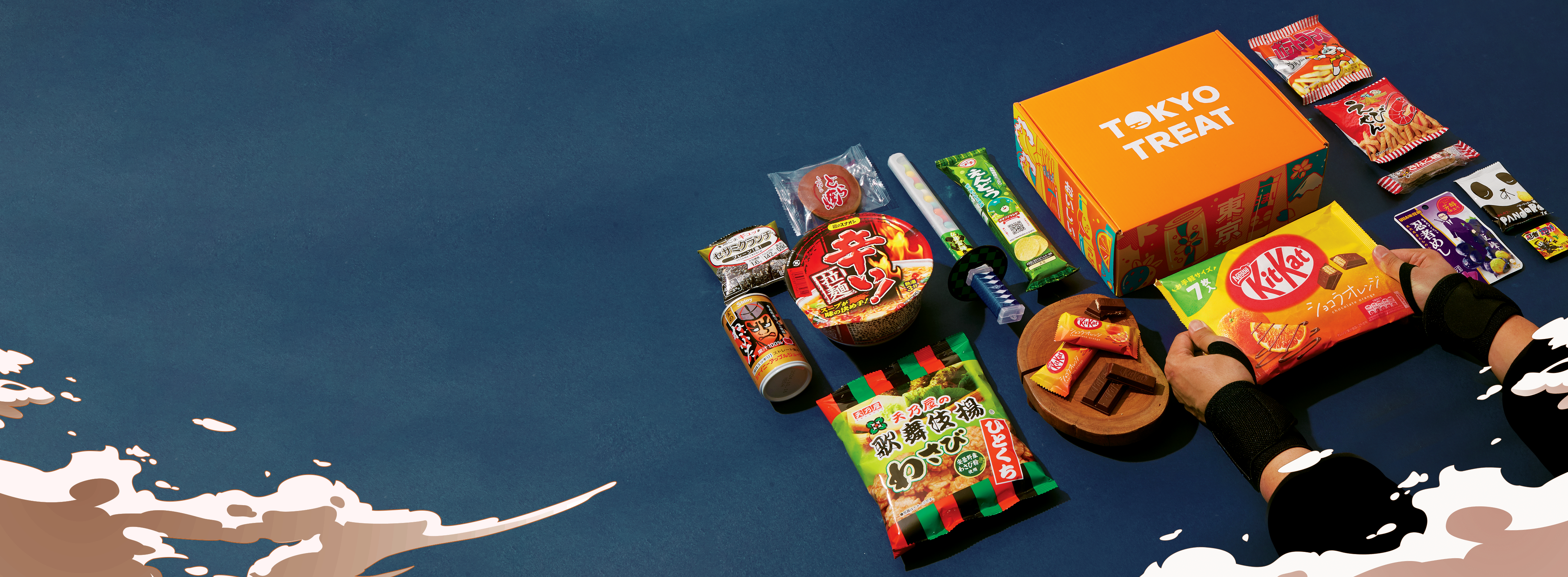 TokyoTreat box sits on a dark navy blue background, surrounded by May box items.