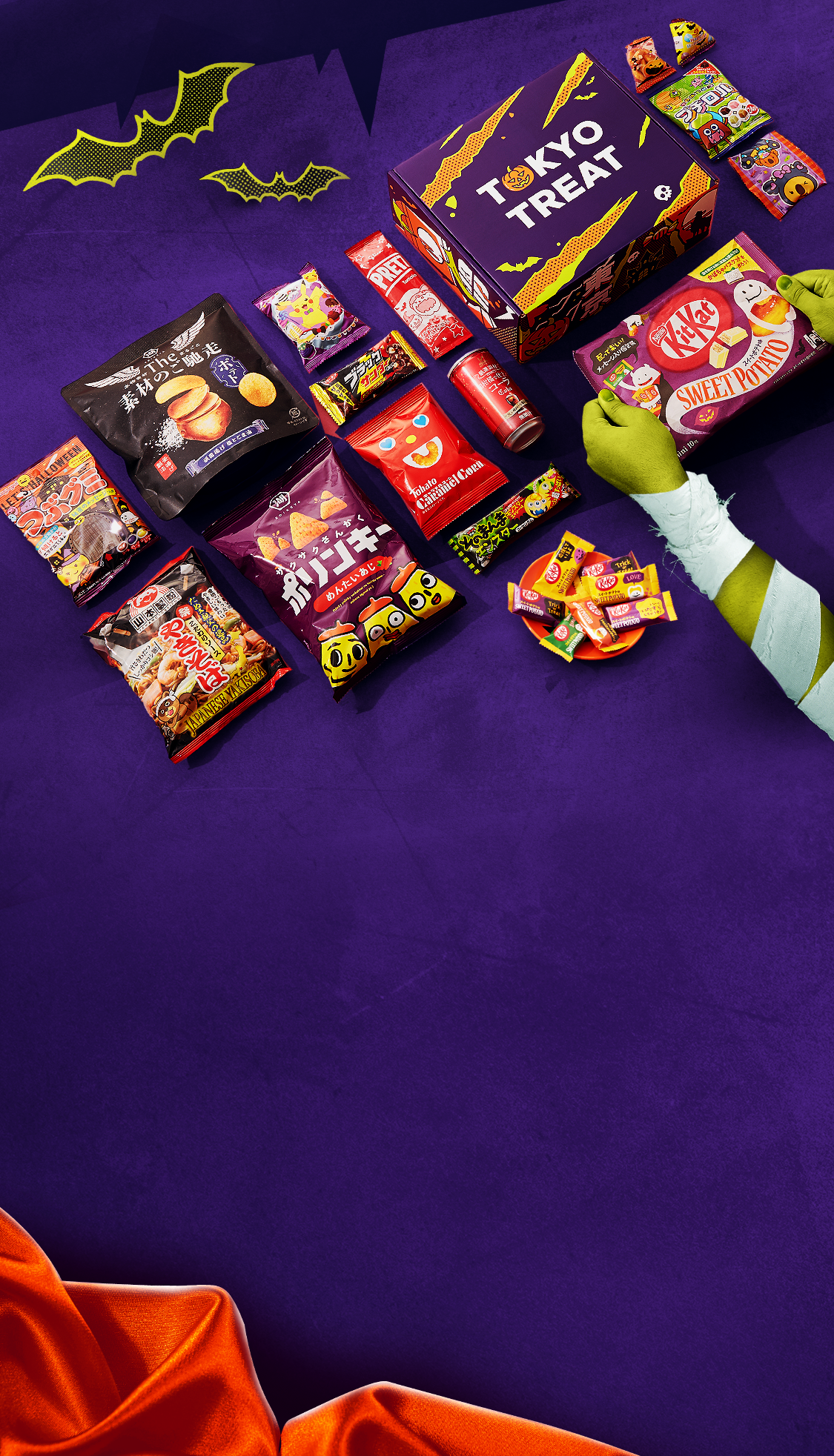 The special Halloween TokyoTreat box sits against a dark purple backrop, surrounded by Halloween motifs.