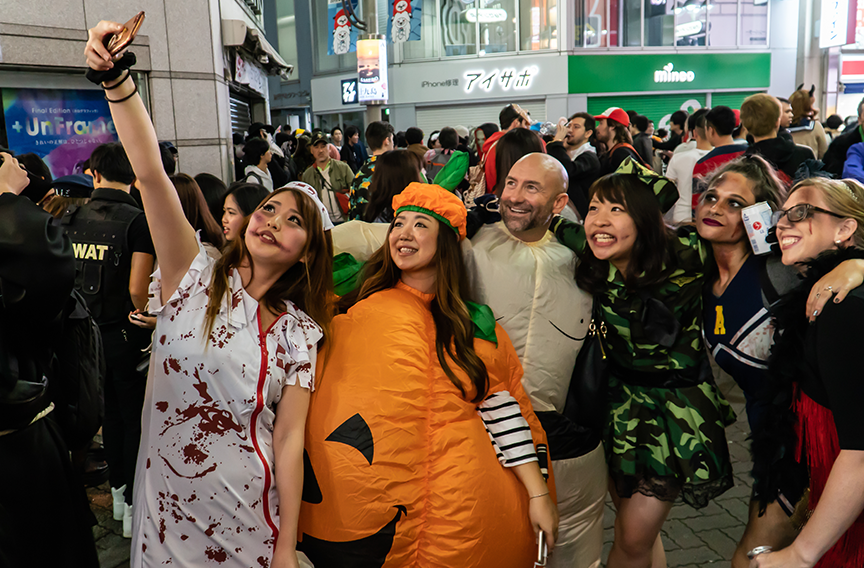 People in costumes celebrating Halloween in Shibuya.