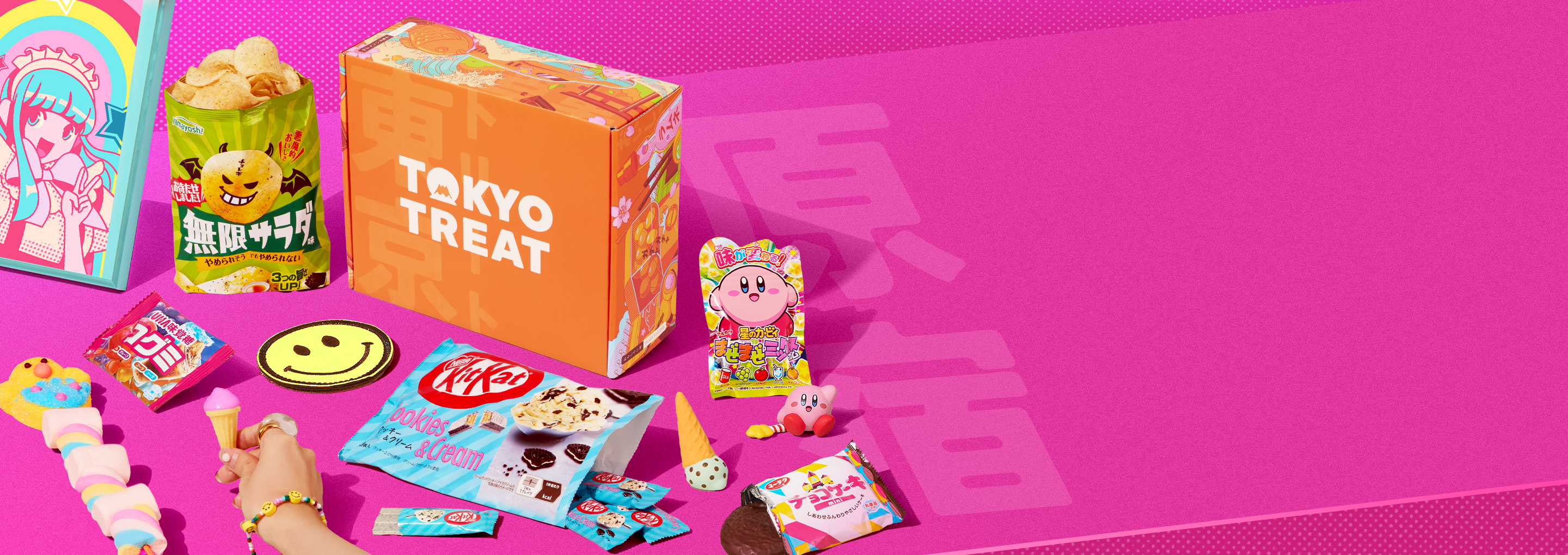 Orange TokyoTreat box on pink background with Harajuku-themed snacks around it 