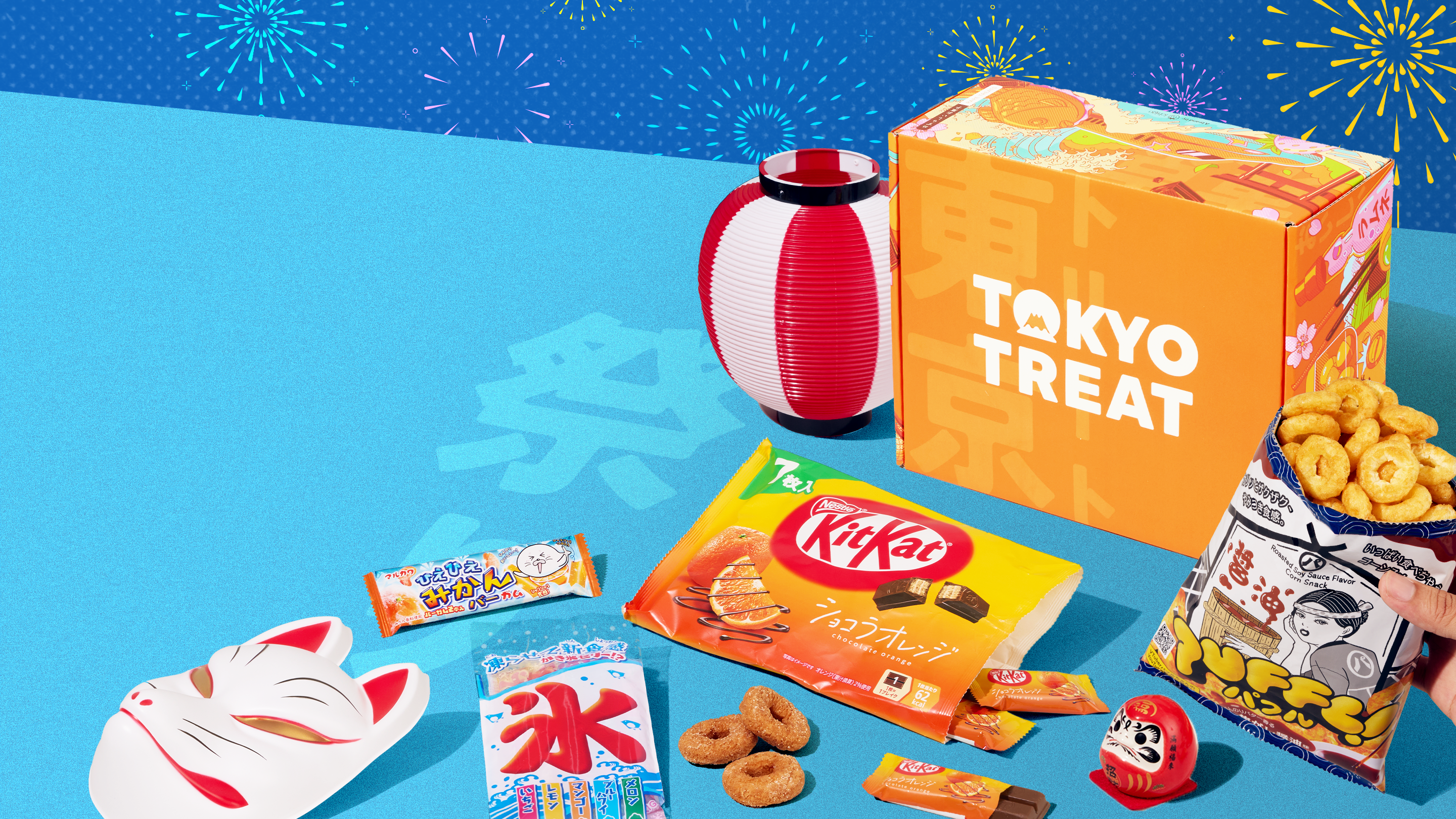 Orange TokyoTreat box with matsuri-themed treats on blue background 