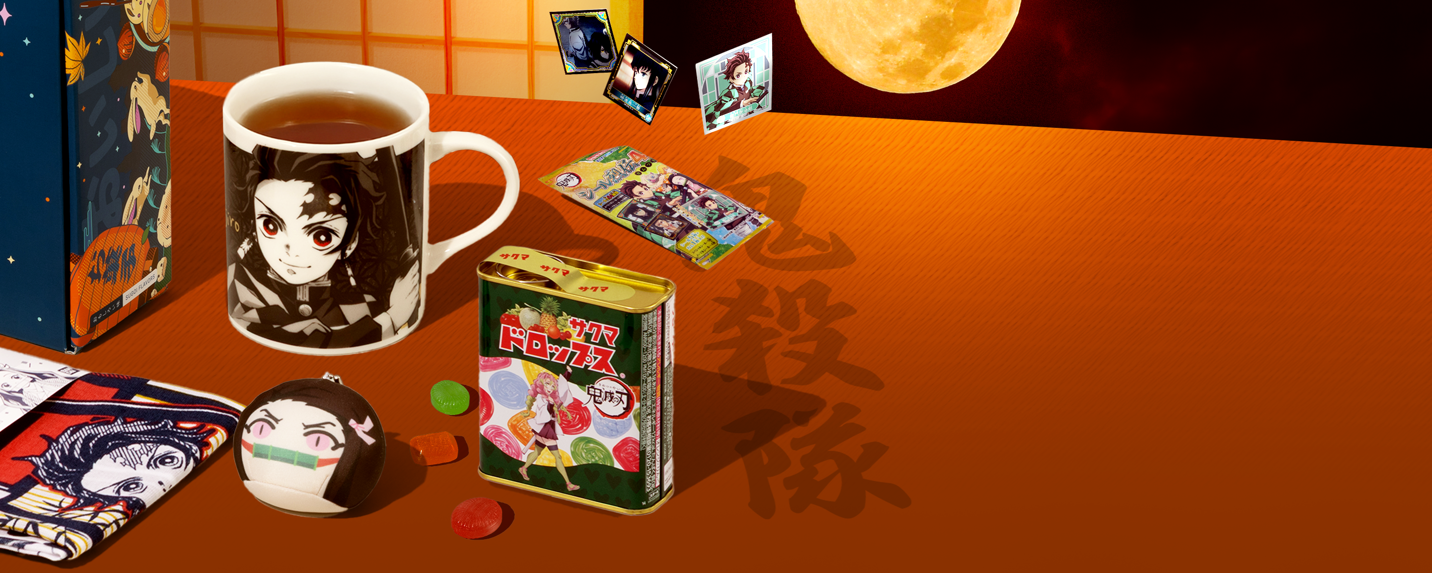 Demon Slayer merch and snacks on a red background with moon in the back