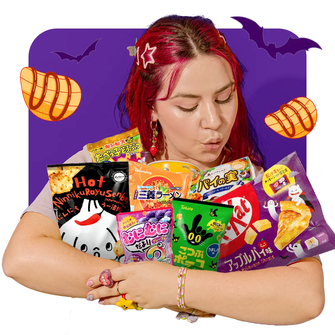 A girl with pink hair holding many delicious Halloween-themed Japanese snacks 
