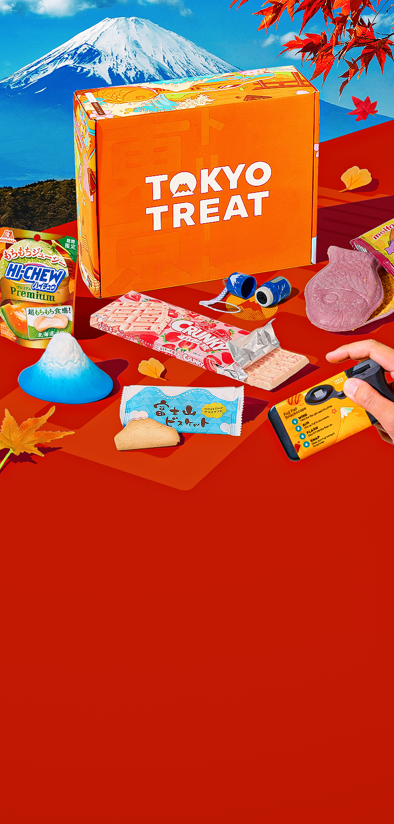 Orange TokyoTreat box with fall snacks around it and Mt. Fuji in the background 