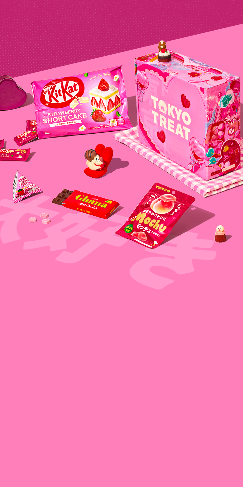 TokyoTreat Valentine's box with lots of red and pink snacks next to it on a pink background 
