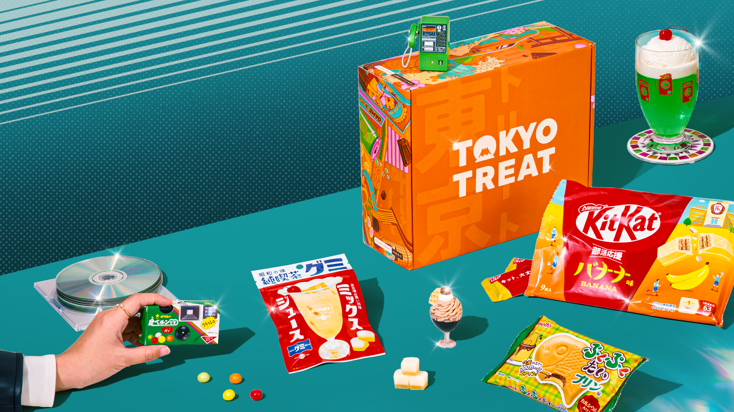 Orange TokyoTreat box with retro-themed Japanese snacks on teal background 