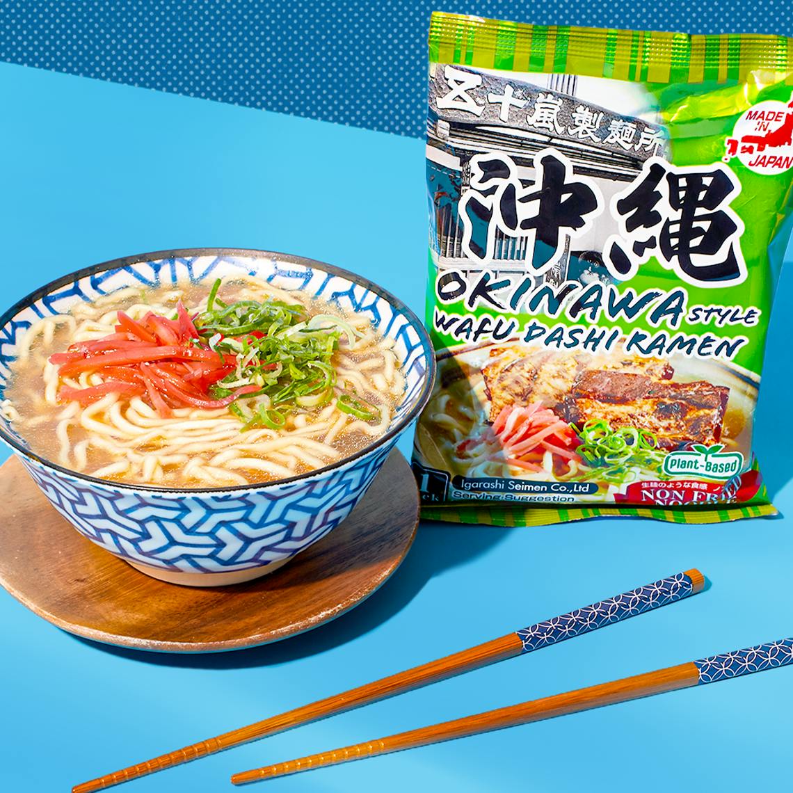 A bowl of ramen with chopsticks in a blue background