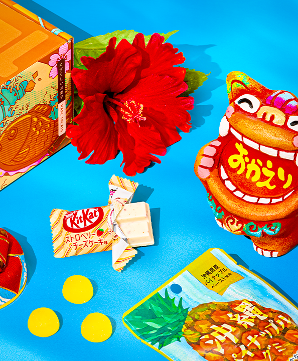 Hibiscus flower with Okinawa snacks around it in blue background