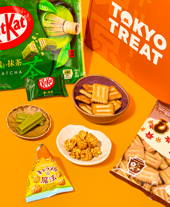 Matcha KitKat and other crunchy, and sweet treats against an orange background