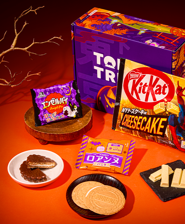 Kitkat, dorayaki, and other Japanese snacks on a Halloween background