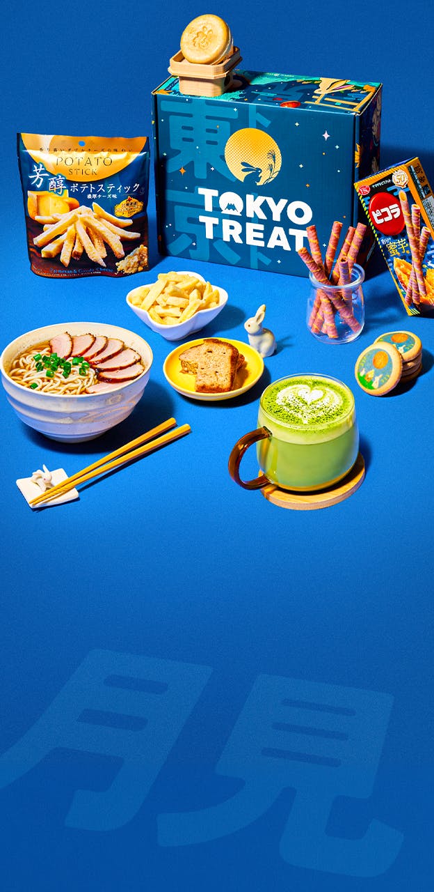 A blue box surrounded by Japanese snacks on a blue background