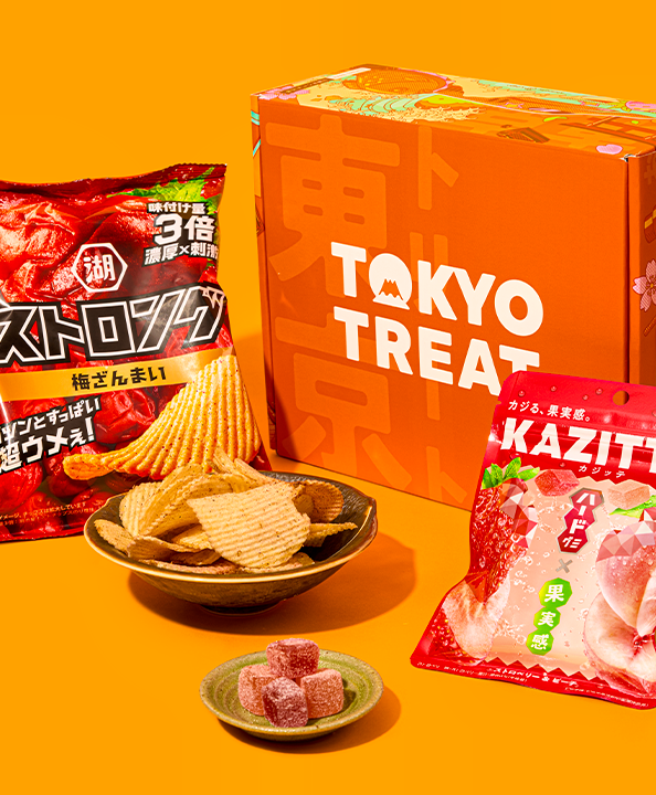 Gummies and potato chips against an orange background