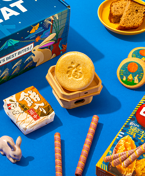 A box and Japanese snacks on a blue background