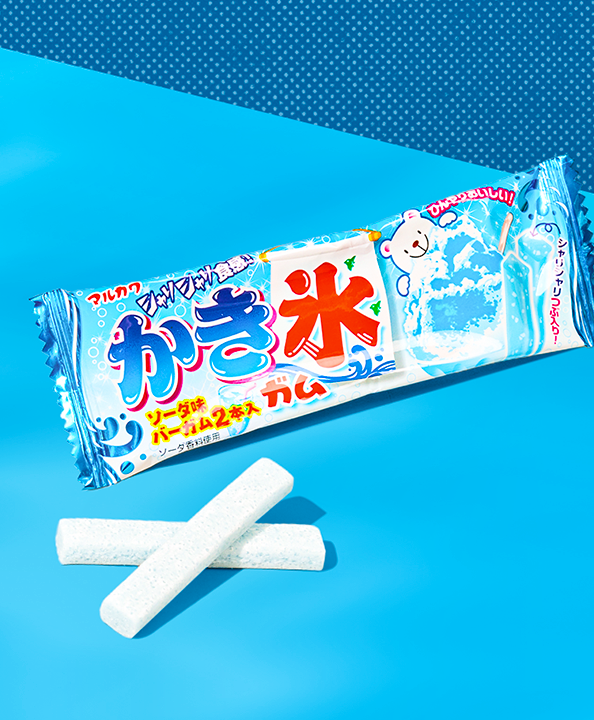 A pack of gum with a bear in the packaging in a blue background