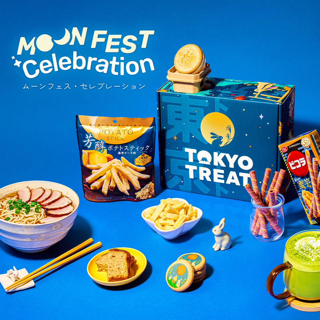Blue TokyoTreat box surrounded by snacks on a blue background