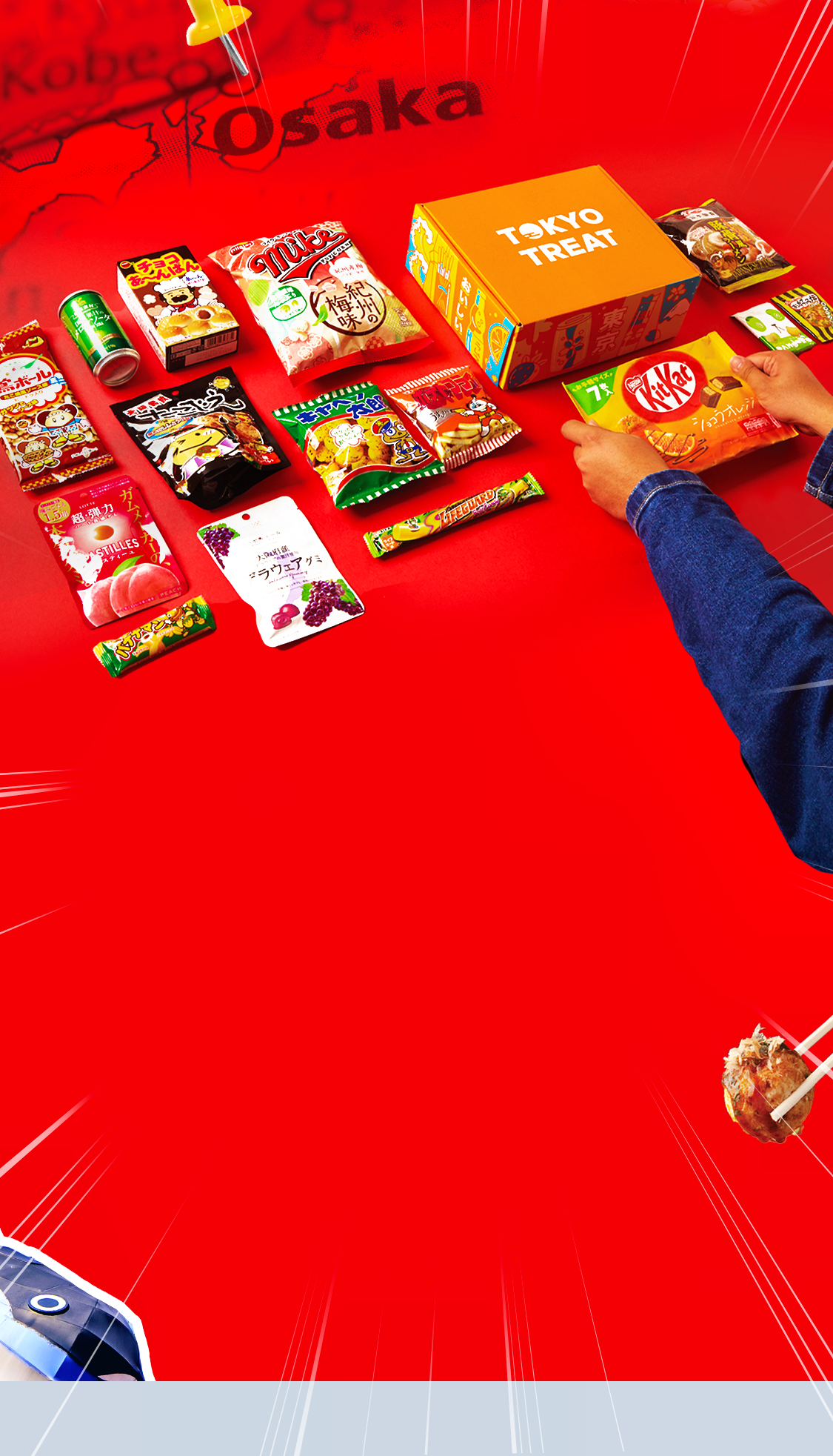 TokyoTreat box sits on a red background, surrounded by box items.