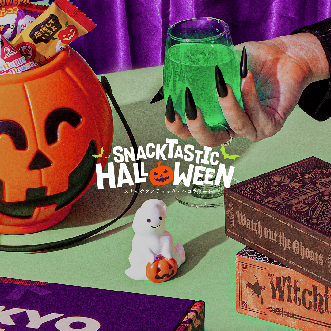 The Snacktastic Halloween logo in front of a variety of spooky items.