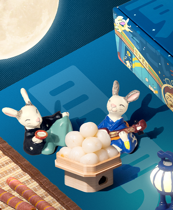 Two bunnies eating mochi under the moonlight