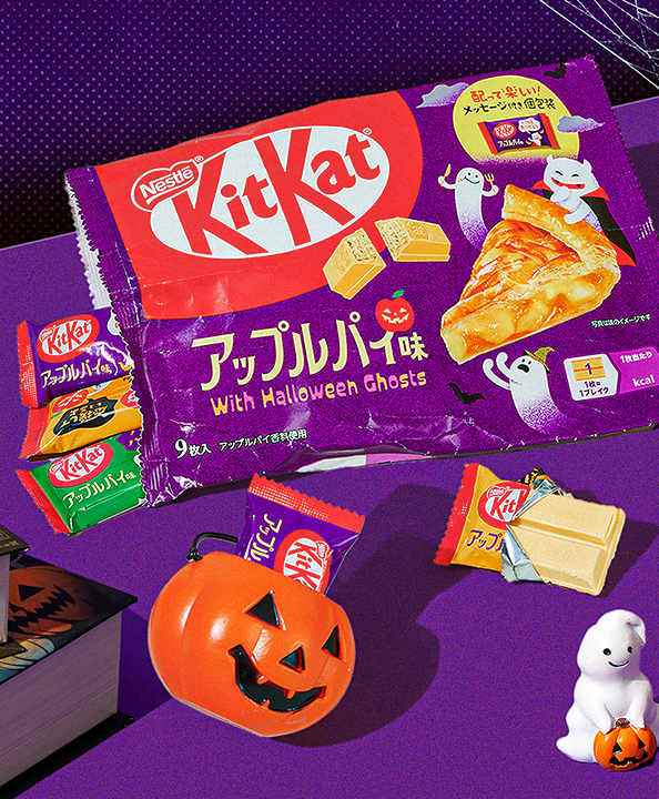 Apple Pie KitKats on purple background with jack-o-lantern prop