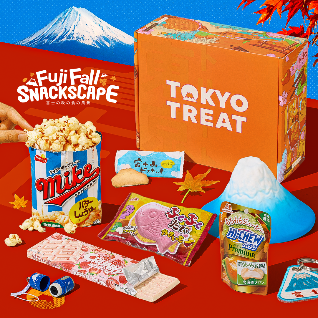 Orange TokyoTreat box with fall-themed snacks around it on red background