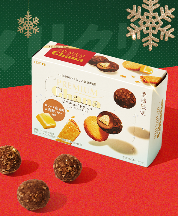 Chocolate truffles on red background with snowflake ornaments around it