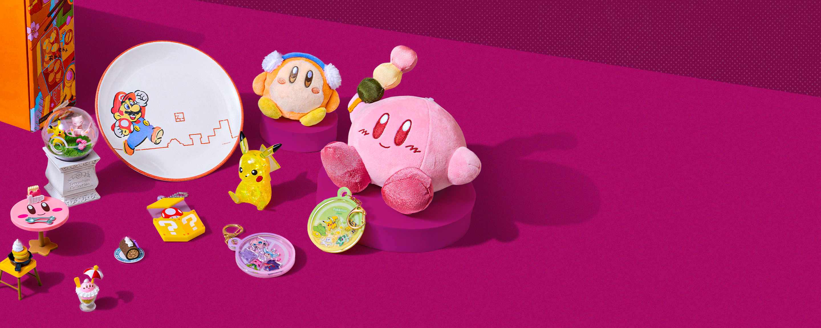Assorted Nintendo merch on a fuchsia pink background