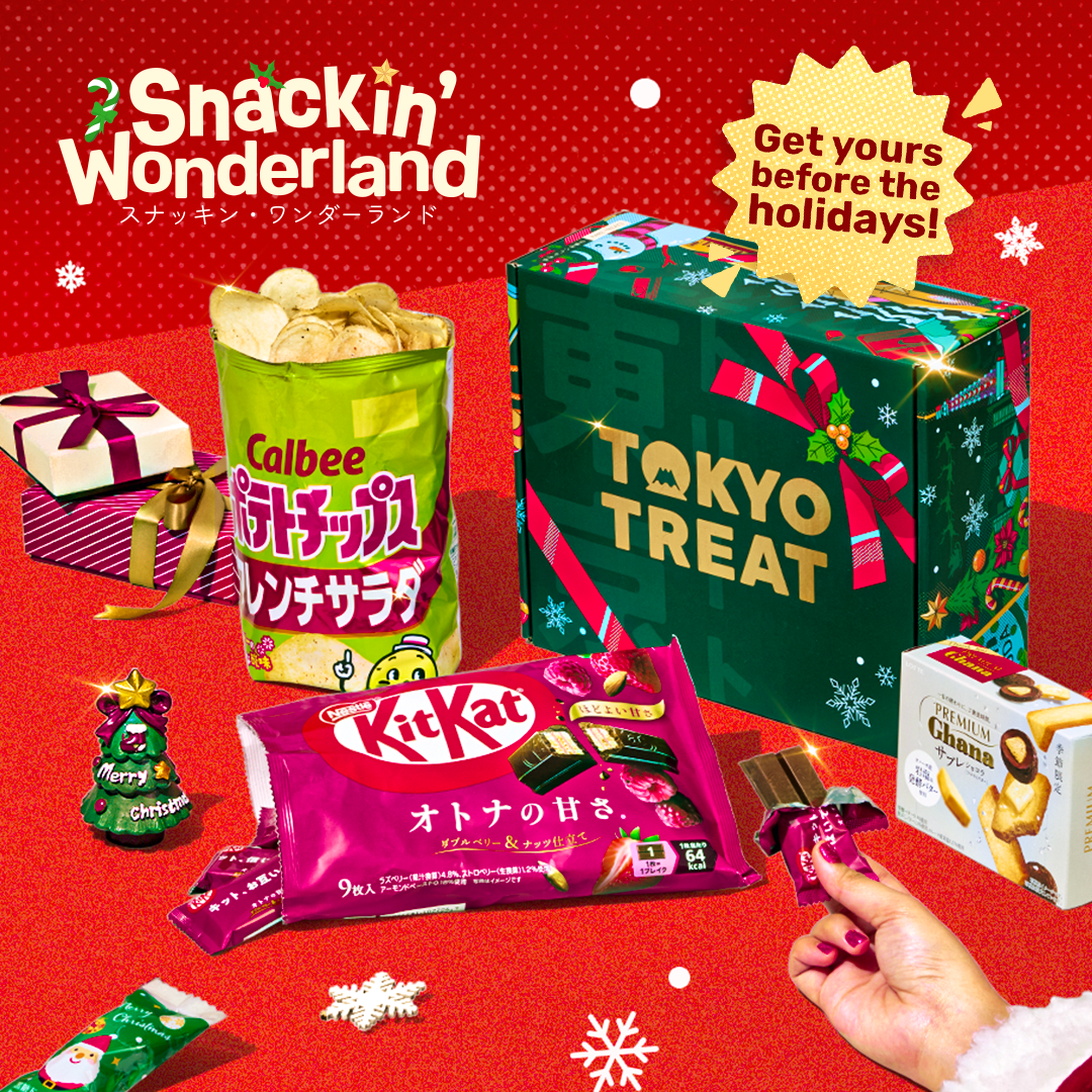 Green TokyoTreat box with Christmas snacks around it on red background