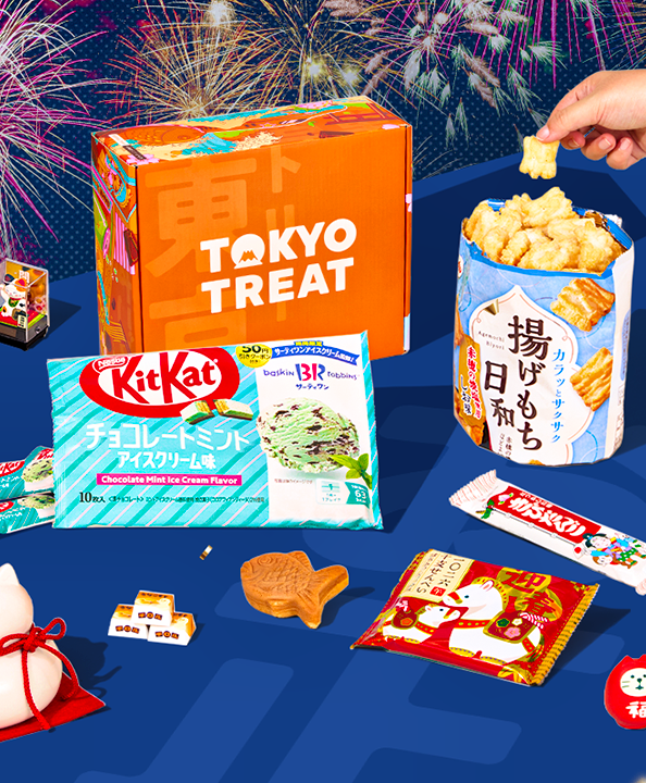 Orange TokyoTreat box with New Year-themed snacks on blue background