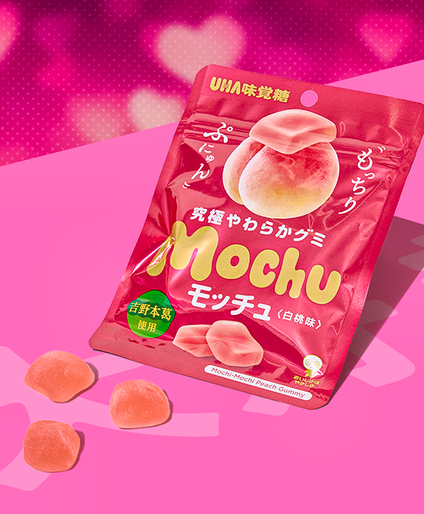 White peach gummies on pink background