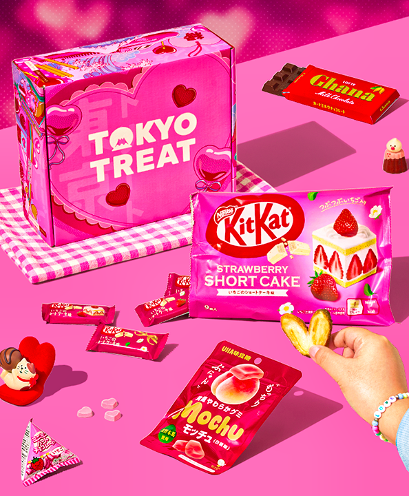 TokyoTreat Valentine's box with lots of red and pink snacks around it on a pink background