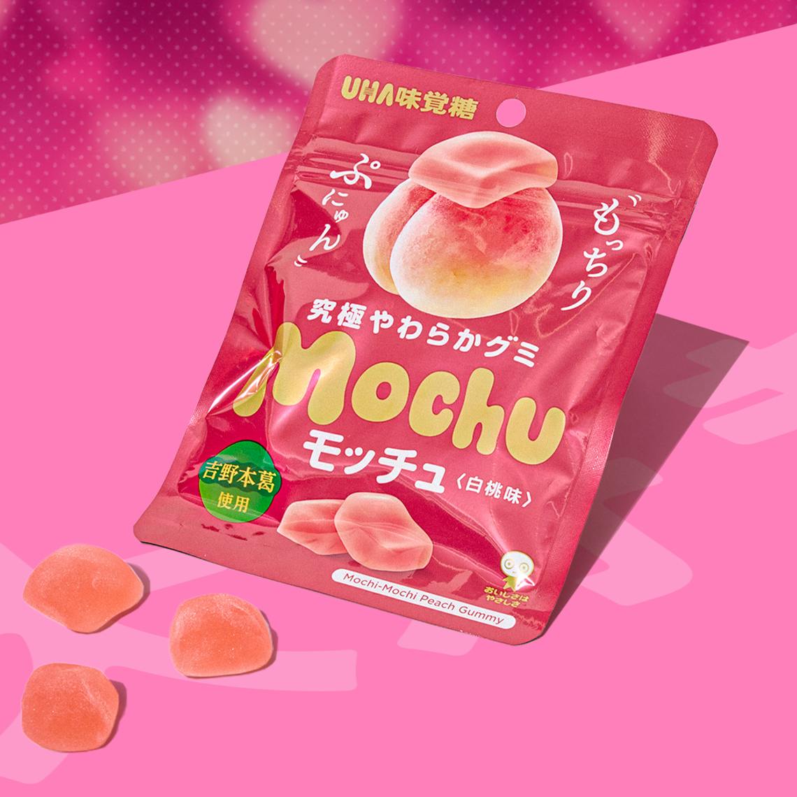 White peach gummies on pink background