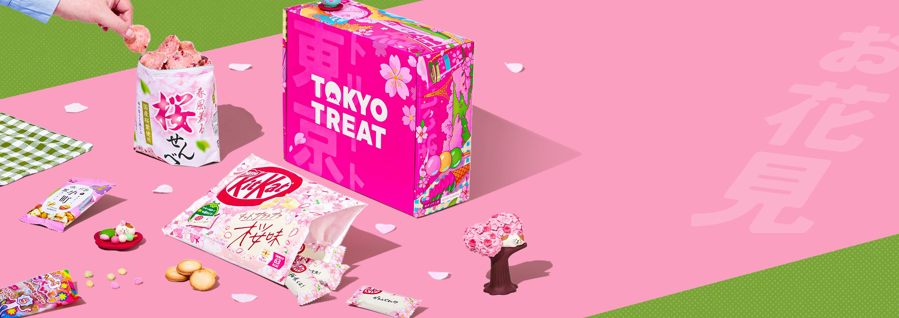 Pink TokyoTreat box with sakura-themed snacks on pink background