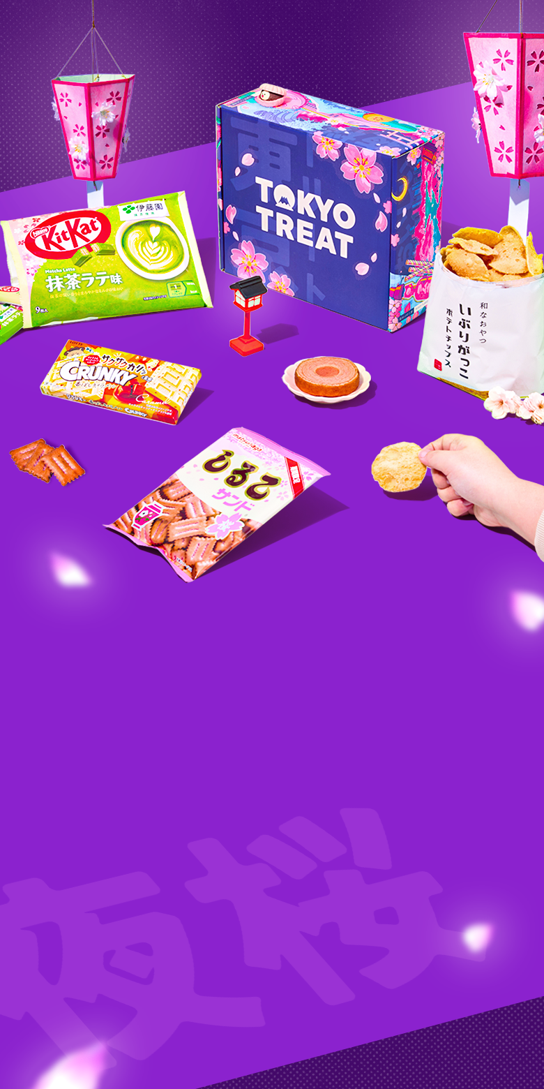 Purple TokyoTreat box with sakura snacks around it and lanterns in the background