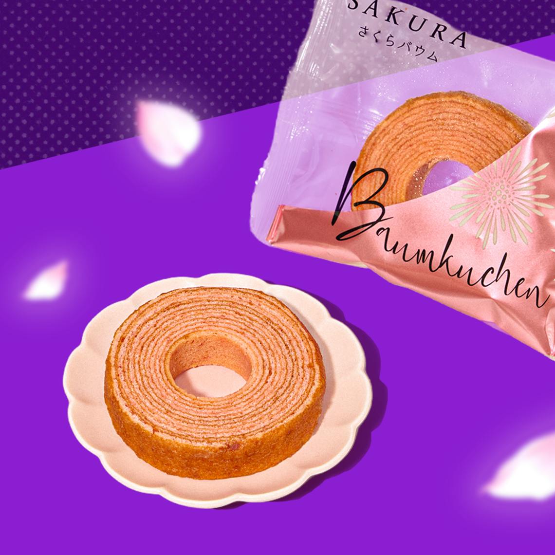 Sakura roll cake on purple background with sakura petals