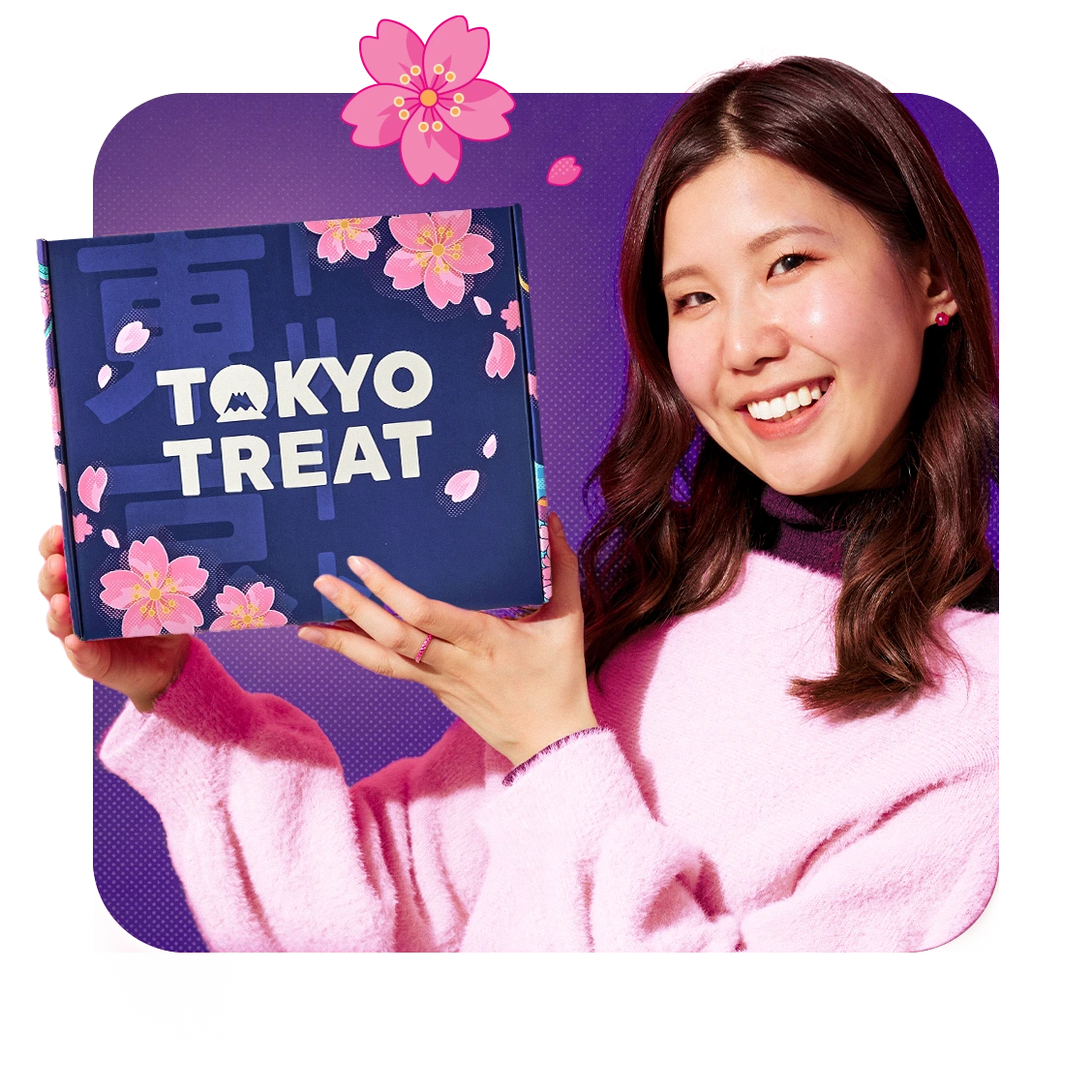 Japanese girl wearing pink sweater holding cherry blossom TokyoTreat box