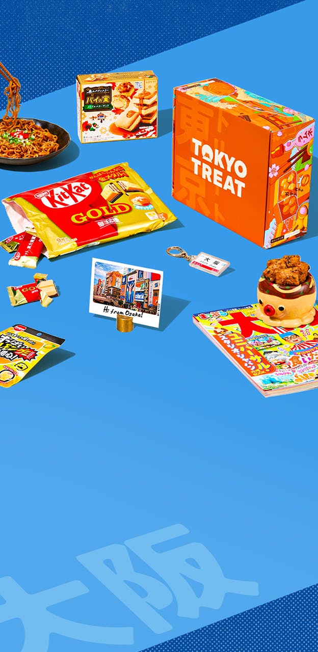 Orange TokyoTreat box with Osaka-themed snacks around it on blue background