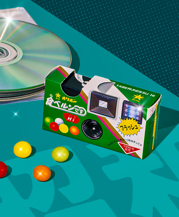 Ramune Candy with CD on teal background