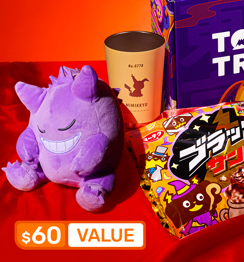 A Gengar plushie, stainless steel mug, and chocolate on a red background