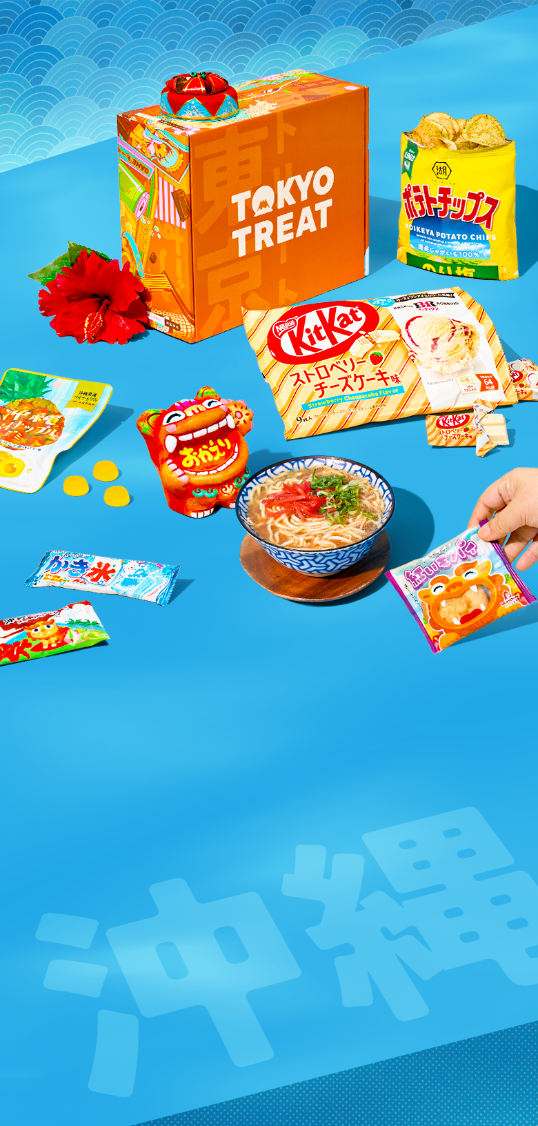Orange TokyoTreat box with Okinawa snacks around it on a blue background